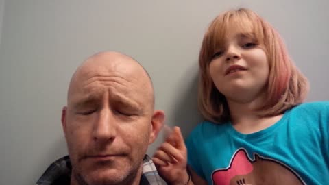 Bored little girl flicks dad's ear