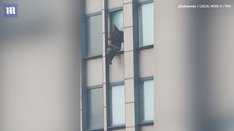 Man who threatened to hurl himself out 35th floor of NYC apartment during FBI bust is suspected CONMAN