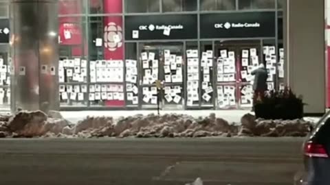 : A video posted online shows the CBC building in Toronto overnight being plastered with posters