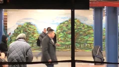 Man hypes up dancer inside of subway station