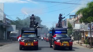 Police Officers Sprays Disinfectant on Makassar Street