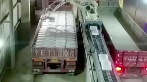 Robots that load bags in a factory.