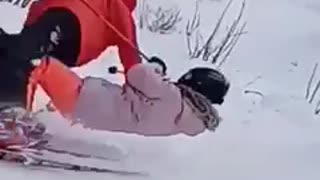 Girl skiing bumps into man in orange
