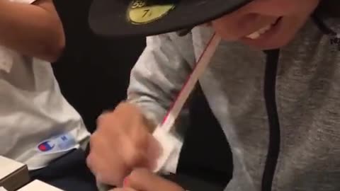 Man heats up a straw and then stretches it