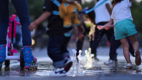 Children playing with a dancing fountain