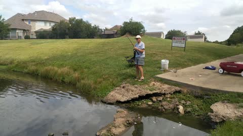 Catching a large catfish from a local pond.