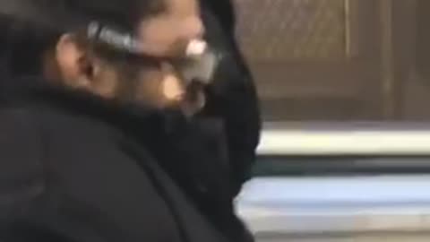 Black coat man wears swim goggles on subway