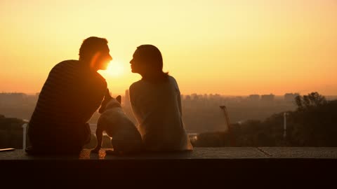 A couple in love watching a romantic sunset