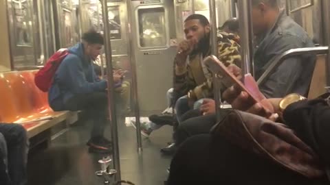 A man smoking a full size hookah on subway train