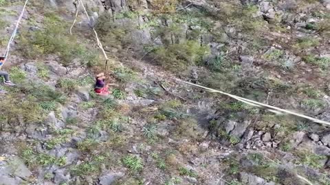 Talented Dude Catches Football while Balancing on High Slackline