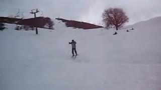 Teen snowboarding down a hill falls and does a scorpion