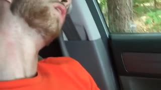 Orange nike shirt guy is asleep in driver's seat