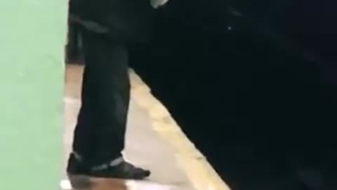 Man sprays water on subway track