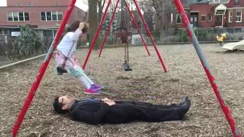 Awesome_dad_perfects_swing_stunt_at_the_park