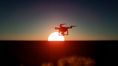 Drone flying over the sea during a sunset