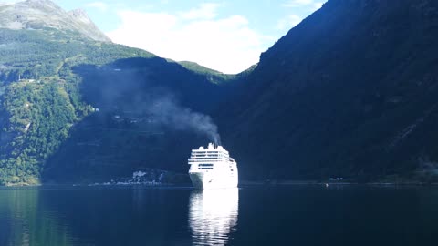 big cruise ship at the geiranger fjord in norway