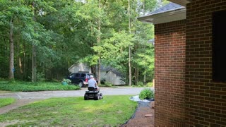 Father and Son mowing the lawn