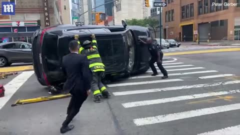 firefighter's leg is crushed by propped-up car in Manhattan