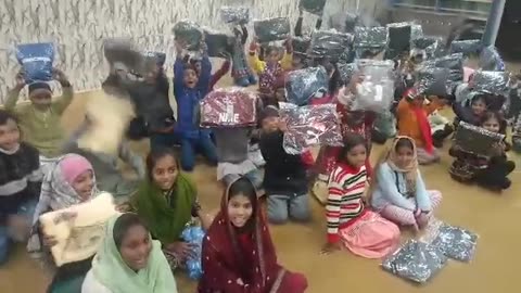 Pakistani orphans thankful to Uncle Ray for winter coats and clothes.