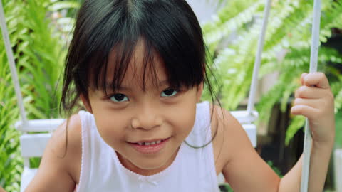 Little Girl Swings , Her Face is funny