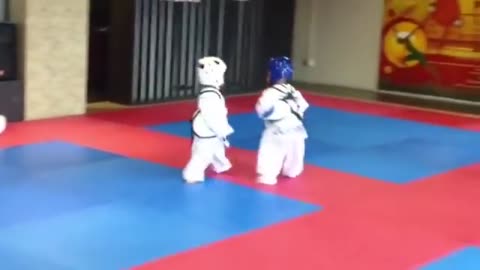 Adorable kids fighting Kung Fu. So sweet