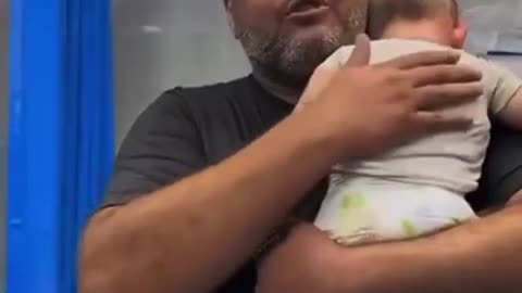 A father was filmed giving his daughter a final hug after she was killed an airstrike.