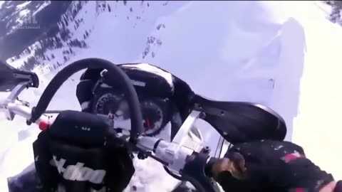 Lucky man on snowmobile is inches from falling off mountain