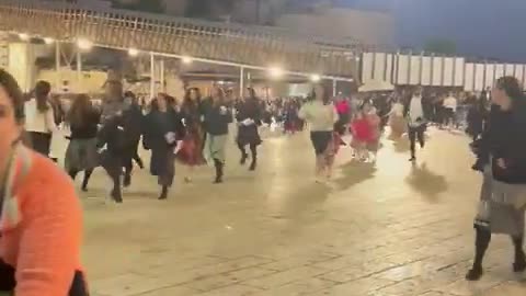 Israelis praying at the Western Wall take cover during the Hamas rocket attack against Jerusalem