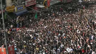 Mourners attend the funeral of Palestinians killed in an overnight Israeli raid