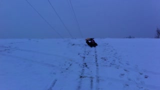 Carson Trying to Slide Down a Hill on a Snow Sled