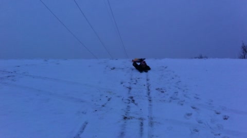 Carson Trying to Slide Down a Hill on a Snow Sled
