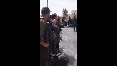 A man with a marked American accent gives an "encouraging" speech to a group of Soldiers in Israel