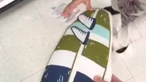 Guy holding surf pillow kid knocks it out off his hand