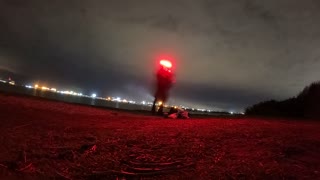 Night lapse. Next to a river . Packing gear away.