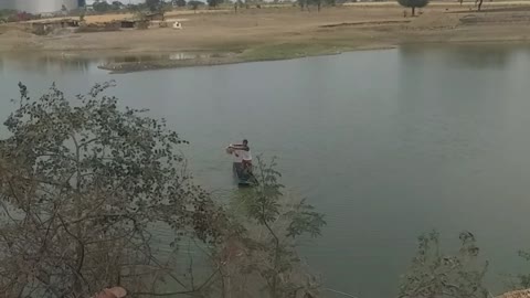 Guy Who Is Catching Fish In Pond.
