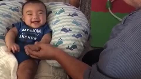 Baby hilariously arm wrestles with uncle