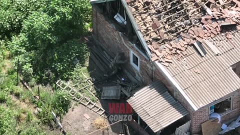 A Russian soldier blows up a house.