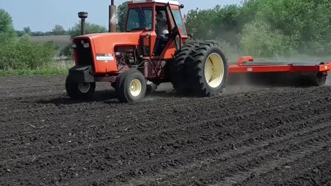 Allis Chalmers 7050 pulling a 20 foot land roller