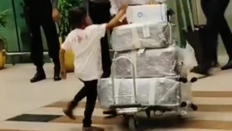 A little boy is welcoming his father at the airport