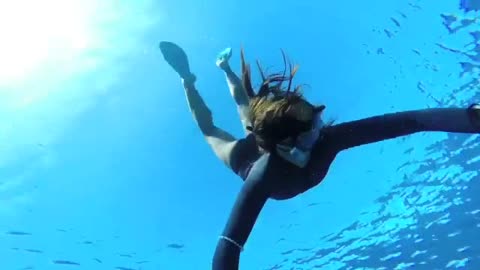 Adorable Female Diver Enjoys Her Time Under Water
