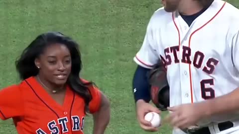 Simone Biles flips during incredible first pitch