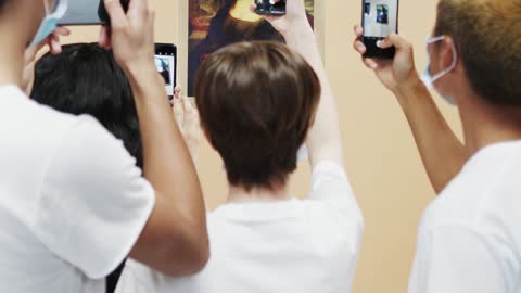 Group of People Taking Picture Of A Painting Of Mona Lisa With Face Mask