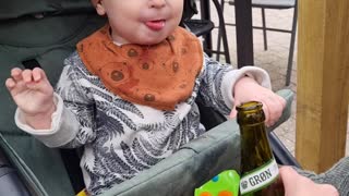 Baby loves beer bottle