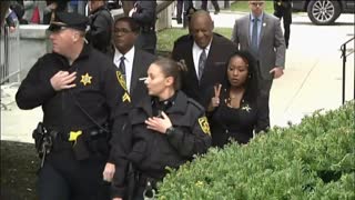 Topless woman protests as Bill Cosby arrives at courthouse