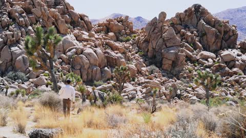 A Person Moving Towards The Natural Rock Formations