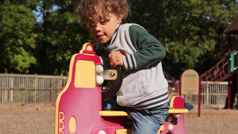 Adorable Little boy with Down Syndrome at Playground