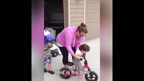 Funny kid not giving cycle to his brother