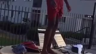 Omg red shorts kid jumps from table to pool, hits face