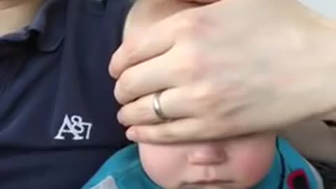 Dad Puts Baby to Sleep by Sliding Hand on Face