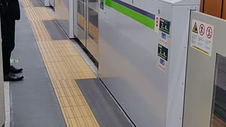 Shinjuku Subway Line Train in Tokyo Pulling Into the Station with "Train Coming" Flashing Light